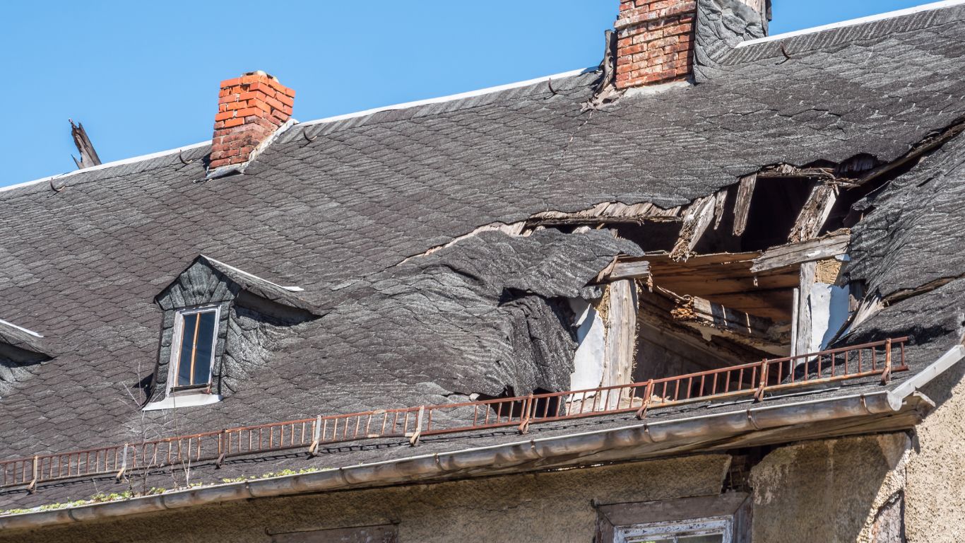 Damaged roof with significant storm damage, highlighting the need for storm damage restoration in Baton Rouge.